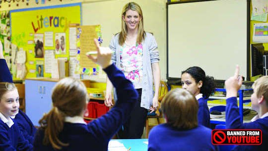 teacher standing in front of students in an open classroom